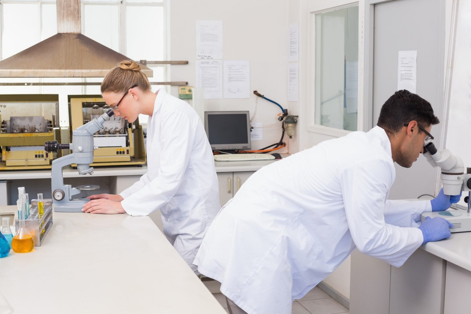 scientists using microscope in the laboratory